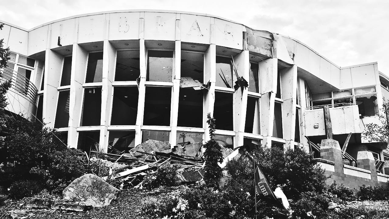 The library after the storm, its iconic windows broken and landscaping destroyed.